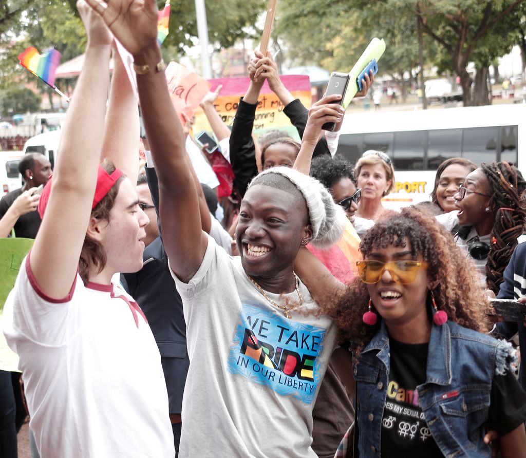 Jubilant LGBT activists celebrate outside the Hall of Justice in Port-of-Spain in April.