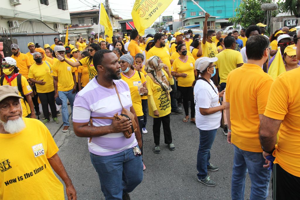 UNC supporters walk the streets during the joint walkabout wiith Saddam Hosein for Barataria/San Juan and St Joseph Colonel Ahloy Hunt on Boundary Road Extension in San Juan yesterday.