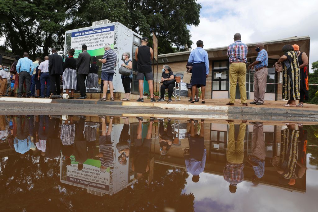 People wait in a queue to get a shot of the Sinopharm vaccination at Wilkins Hospital in Harare, Zimbabwe, on Wednesday. Zimbabwe is rolling out its COVID-19 inoculation programme and in the first phase is targeting healthcare workers and the elderly.