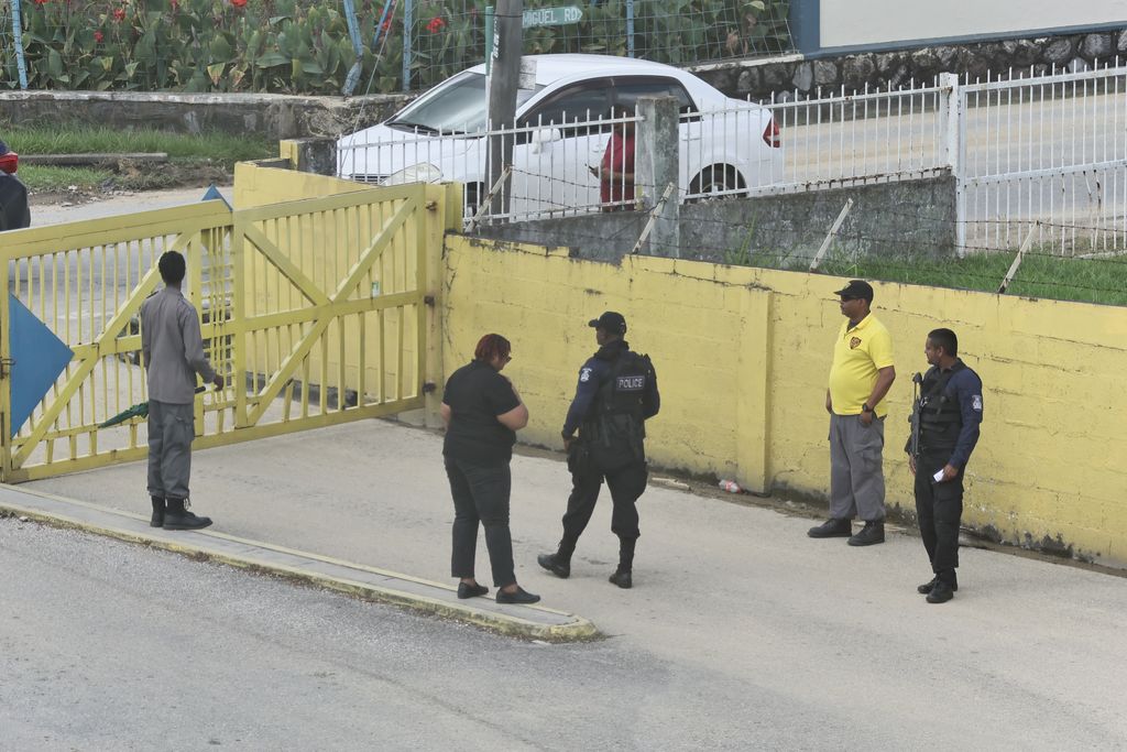 Police officers on the compound of Courts Megastore in San Juan, afer Sunday's shooting of five people by an off-duty police officer.