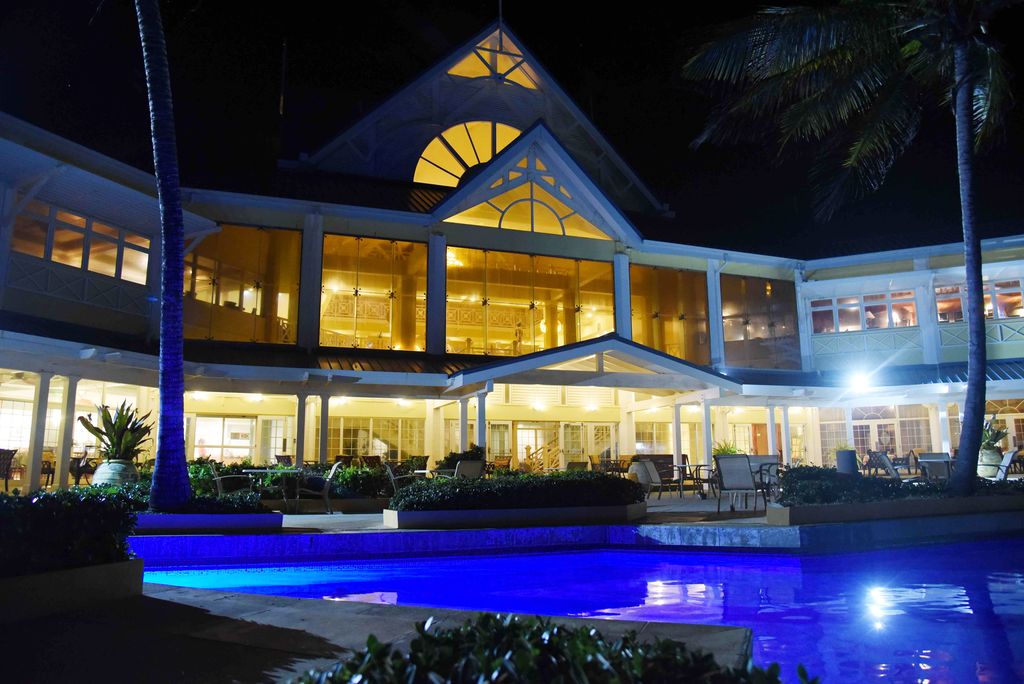 A majestic view of the Magdalena Grand hotel from poolside at night.