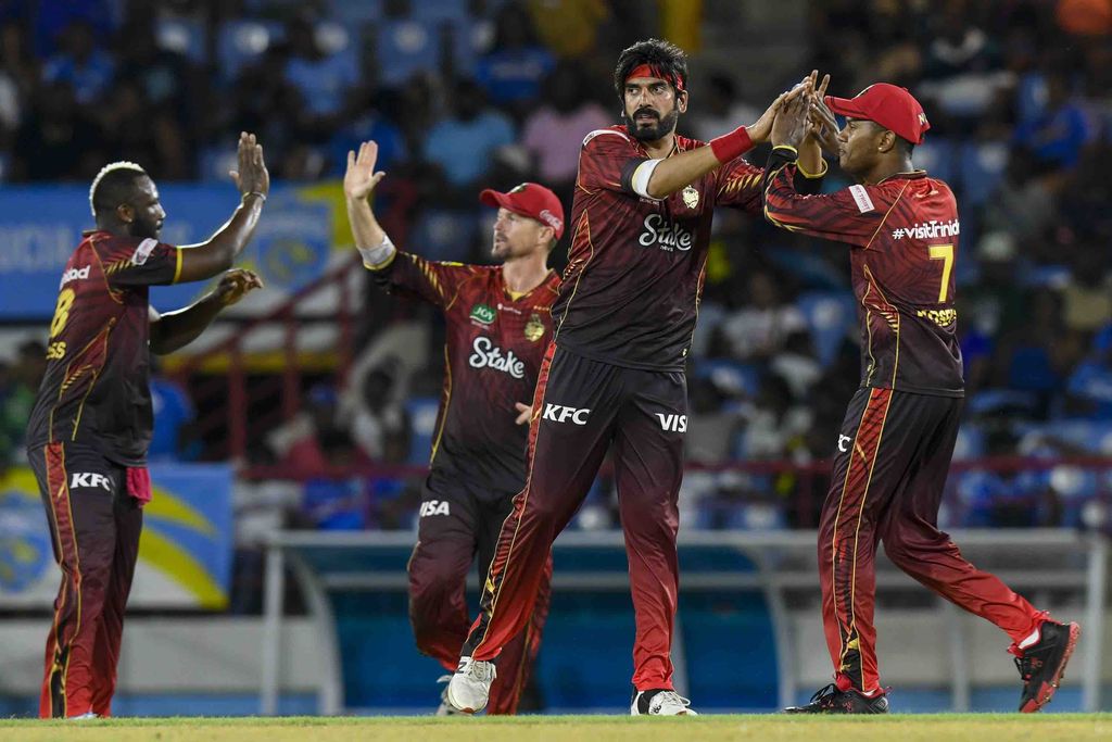Usman Tariq, second right, and Akeal Hosein, right, of Trinbago Knight Riders celebrate the dismissal of Johnson Charles of Saint Lucia Kings during the Men’s 2025 Republic Bank Caribbean Premier League match 10 at Daren Sammy National Cricket Stadium in Gros Islet, Saint Lucia on Saturday. TKR won by 18 runs.