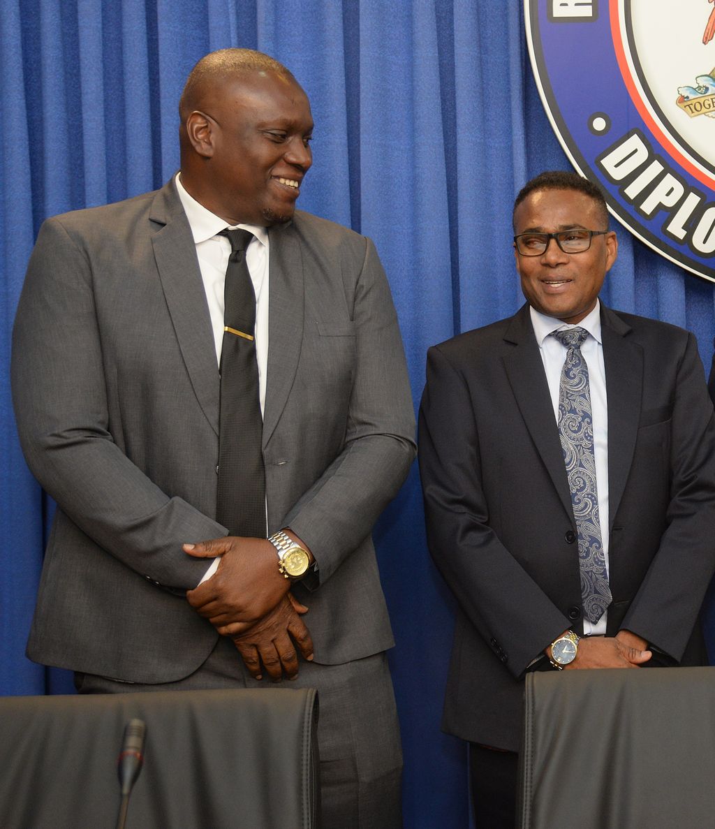 Minister of Sport and Community Development, Phillip Watts, right, interacts with TTFA president, Kieron Edwards during the post-cabinet press briefing at the Diplomatic Centre, St Ann’s, Port-of-Spain, yesterday.